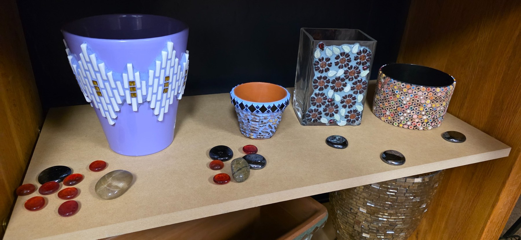 Rebecca's large purple mosaic vessel alongside detailed mosaic pots and a floral glass vessel